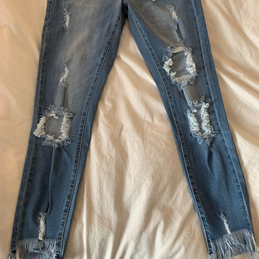 Medium wash destructed frayed hem skinnies